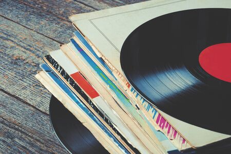 Pile of old vinyl records on the tableの写真素材