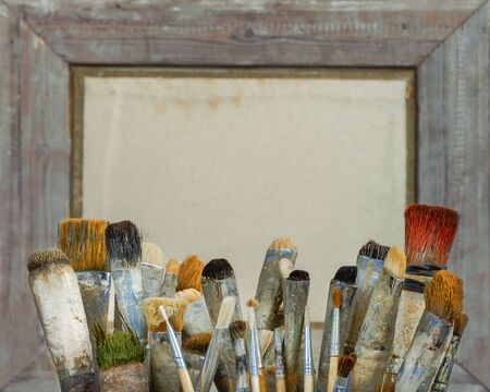 Brushes for painting in the artist's studio on the background of a wooden frameの写真素材