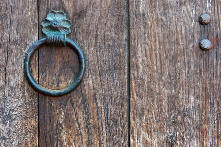 The metal ring-handle on an old wooden door