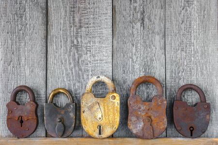 The old locks on a background of wooden boardsの写真素材