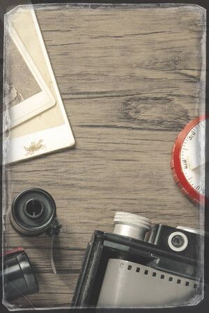 Old photo camera with film, cassettes and old photos.The stylized photo.の写真素材