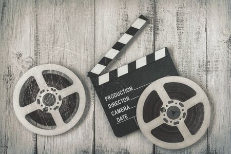 Clapperboards and two reels of film.Black and white stylized photoの写真素材