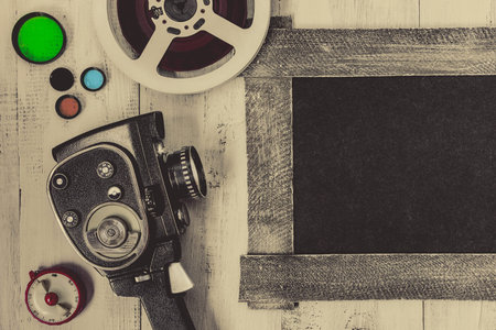 Old movie camera and accessories are painted on a white board.View from above.