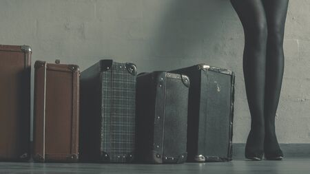 The girl with the old suitcases in the roomの写真素材