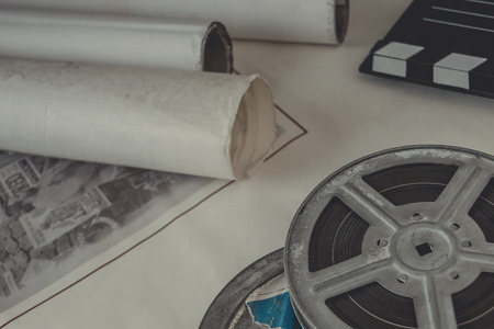 Reel with the film, old movie posters and clapperboardの写真素材