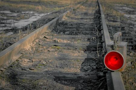 Red train signal lamp standing on the railsの写真素材