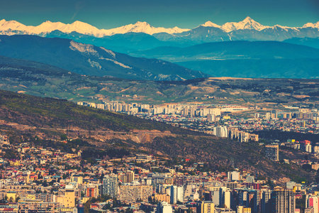 View of the city of Tbilisi against the background of snow-capped mountainsの写真素材