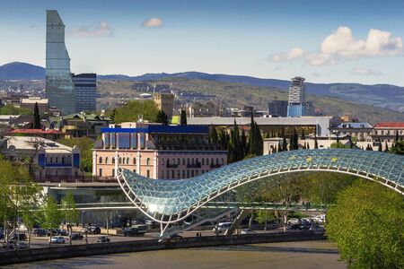 View of the city of Tbilisi on a sunny day.In the foreground is the Bridge of Peaceの写真素材