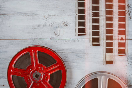 The spools with the film lie on a wooden table