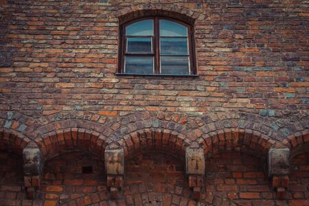 Wooden semicircular window in an old brick houseの写真素材