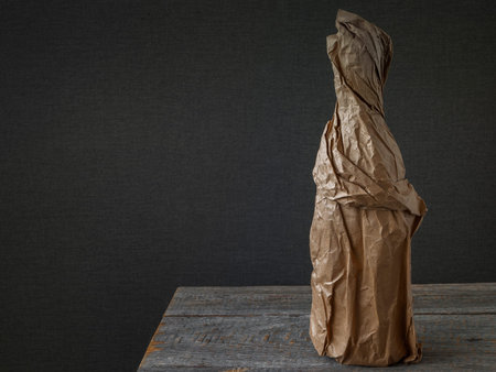 A bottle of alcoholic drink wrapped in a ginger paper bagの写真素材