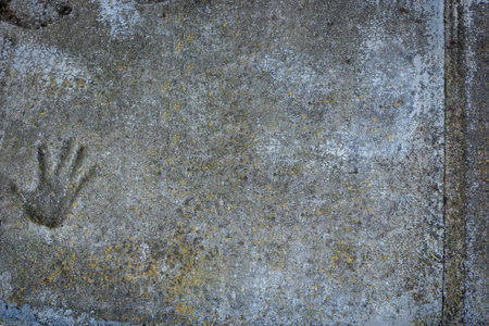 A handprint on the old textured concrete floor