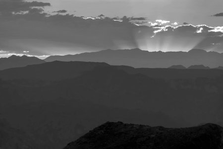 A quiet summer evening with the rays of the setting sun in the mountains.Black and white photosの写真素材