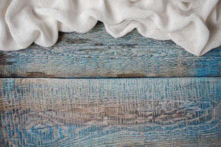 Wrinkled white cloth on an old painted boardの写真素材