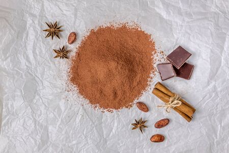 cocoa powder cocoa beans star anise cinnamon on crumpled paperの写真素材