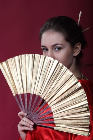 Beautiful brunette girl in a japanese kimono with the funの写真素材