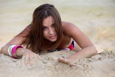 Attractive young women lie on the beachの写真素材