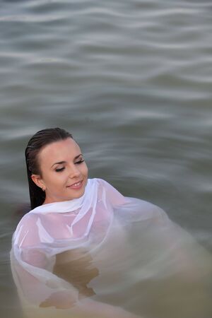 Attractive young woman swim in the riverの写真素材