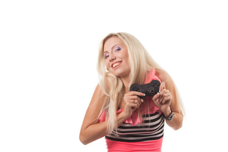 Young blond girl play wideogame by gamepad on the white isolated background