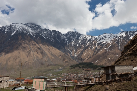 View of the Georgian village of Kazbegi a mountain cliffのeditorial素材