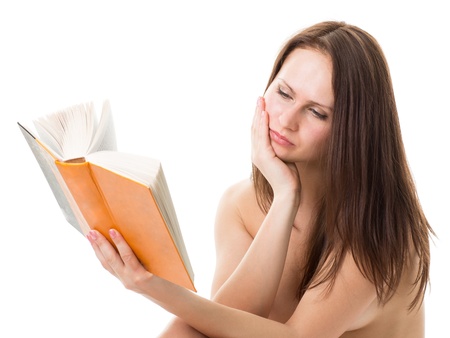 Beautiful naked girl reading a bookの写真素材