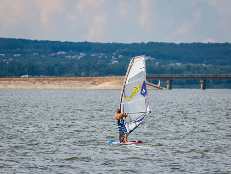 KHARKIV, UKRAINE-JULY 21: WindsurfingÂ Â 21, 2013 in Kharkiv, Ukraine. Windsurfing of yacht club Soich.のeditorial素材
