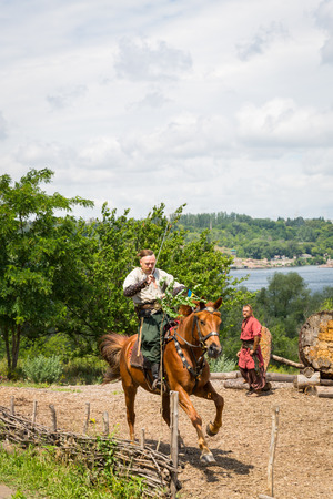 ZAPORIZHIA, UKRAINE-JUNE 21: Ukrainian Cossacks 21, 2014 in Zaporizhia, Ukraine. Show of Ukrainian Cossacks in Cossacks Museum on the island of Khortytsyaのeditorial素材