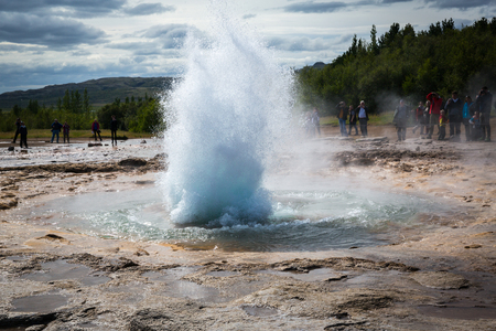 Geyser Strokkyur spewing water into the geothermal area Haukadalurの写真素材