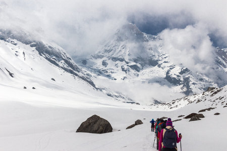 NARCHYANG, NEPAL-MARCH 23: A group of tourists 23, 2015 in Narchyang, Nepal. A group of tourists on a route to the Annapurna  base camp.のeditorial素材