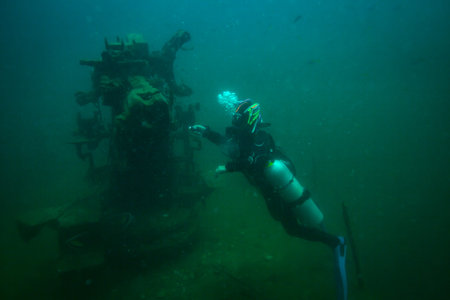 Scubadiver in a sidemount configuration of equipment
