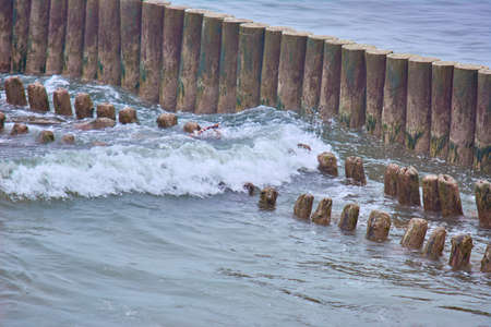 Embankment Zelenogradsk. Baltic Sea. Surf. Wooden logs of a breakwater. Kaliningradの写真素材