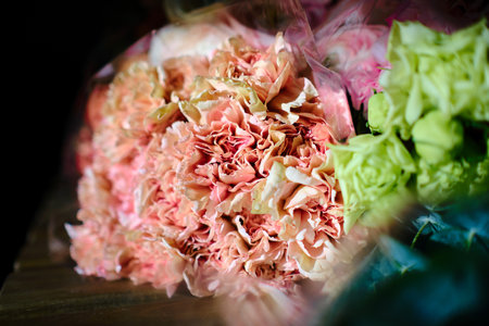 Background for a holiday card for Valentine's Day or March 8. Flowers on a dark background on a wooden old table.の写真素材