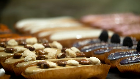 Delicious eclairs on the counter of the store.