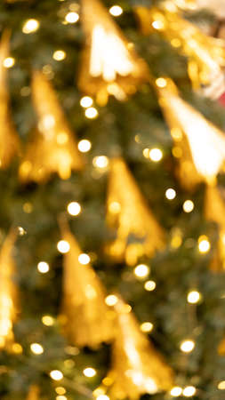 Yellow bokeh abstract winter background. Blur defocused glitter lights. Circular points. Colorful.の写真素材
