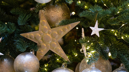 Decorated Christmas tree. Vintage toning. Yellow star and white balls