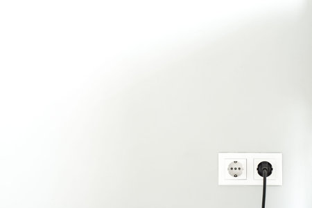 White socket. Power socket. White outlet on the wall.