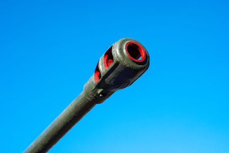 Trunk of an artillery gun against the blue sky