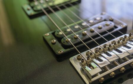 Electric guitar part close-up. Neck and humbucker pickup. Horizontal composition. Studio shot.の写真素材