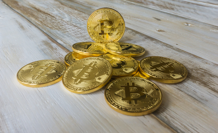 Golden Bitcoins on a wooden table. Photo new virtual moneyの写真素材