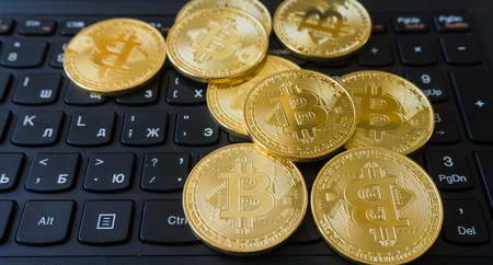 Golden Bitcoins on a laptop keyboard. Cryptocurrencyの写真素材