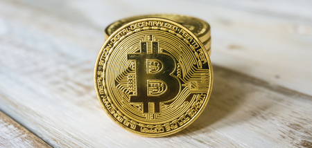 Golden Bitcoins on a wooden table. Photo new virtual moneyの写真素材