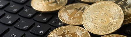 Golden Bitcoins on a laptop keyboard. Cryptocurrencyの写真素材