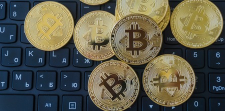 Golden Bitcoins on a laptop keyboard. Cryptocurrencyの写真素材