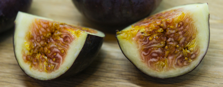 Fresh fig fruits arranged on wooden tableの写真素材