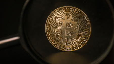 A look at the bitcoin through a magnifying glass. Concept Valuationの写真素材