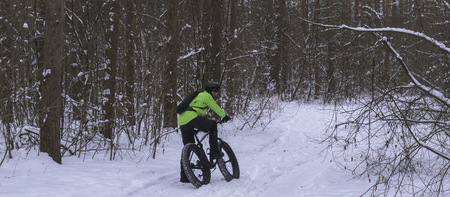 Fat bike also called fat bike or fat-tire bike - Cycling on large wheels in the winter forest.の写真素材