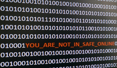 macro computer screen shot with binary code and warning text, concept for computer, technology and online security.の写真素材