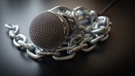 Microphone and chain. Freedom of the press is at risk concept - World press freedom day conceptの写真素材