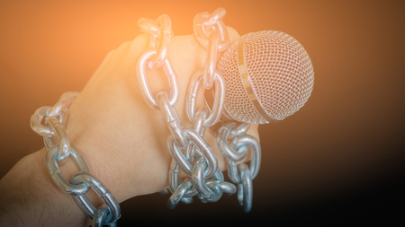 Microphone and chain. Freedom of the press is at risk concept - World press freedom day conceptの写真素材