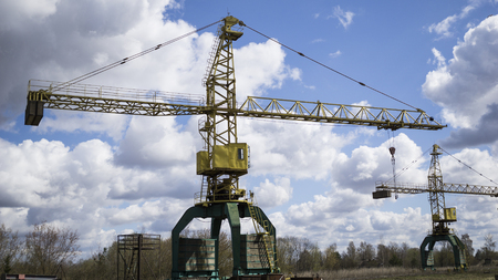 Old, rusty gantry crane, an abandoned plant. Collapse of economy, and shutdown of production capacities have led to collapse. global economic declineの写真素材